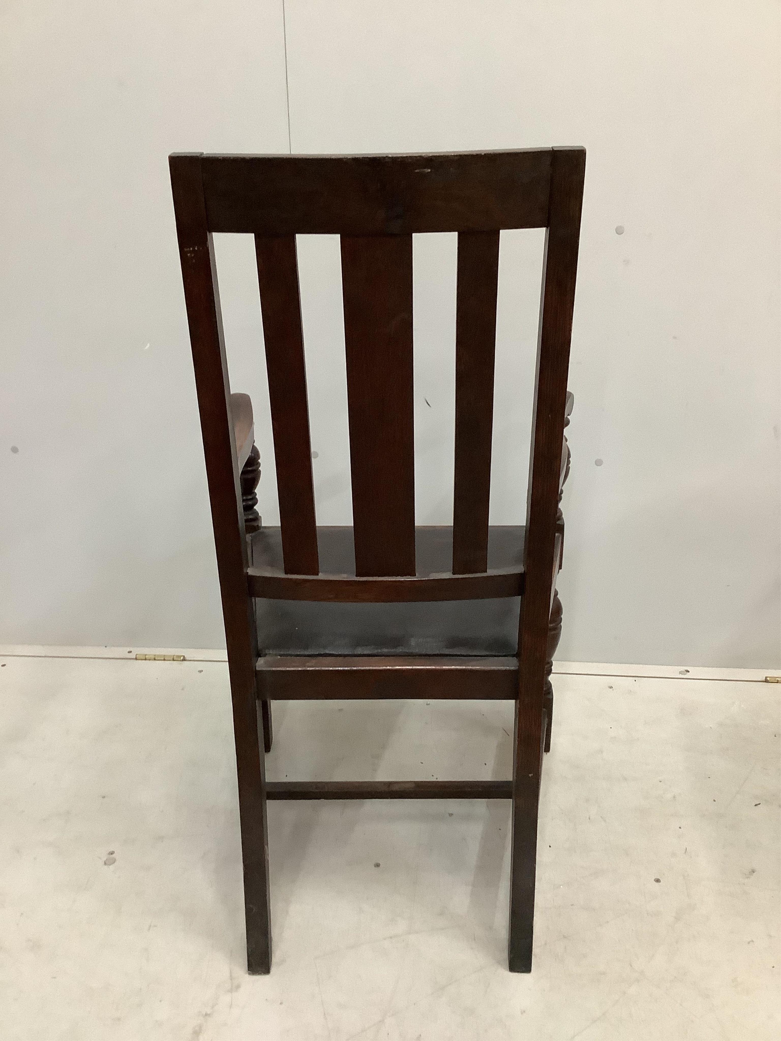 Eight 1920's oak dining chairs, two with arms
